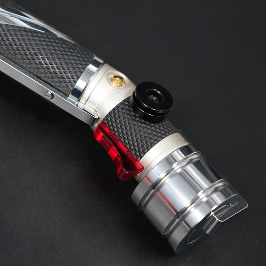 Close-up of the Dooku black belt clip wheel, red accent, and polished pommel section