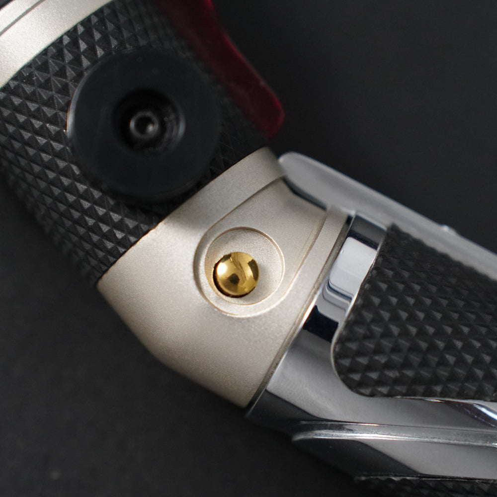 Close-up of the Dooku gold control button, black belt clip wheel, and textured grip