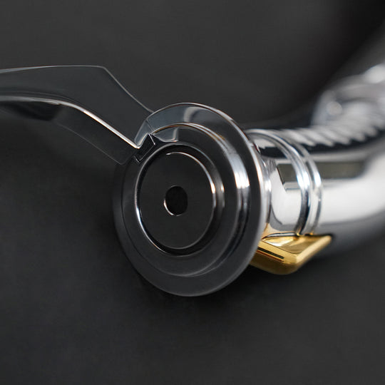 Close-up of the Dooku emitter and blade plug with curved guard and gold accent