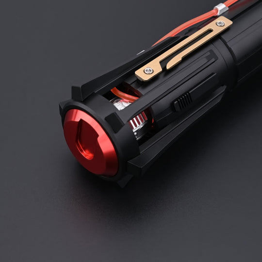 Close-up of the Kylo Saber black grip, bronze accent plate, and red pommel